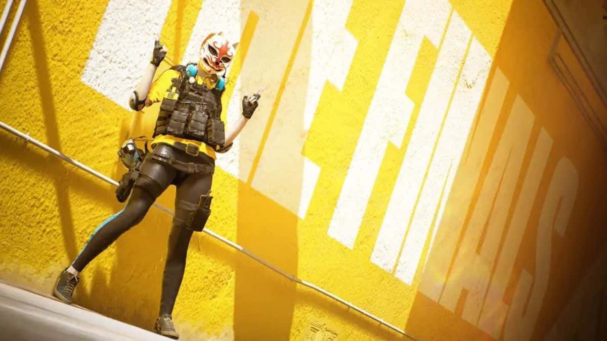 The Finals character standing in front of yellow wall.