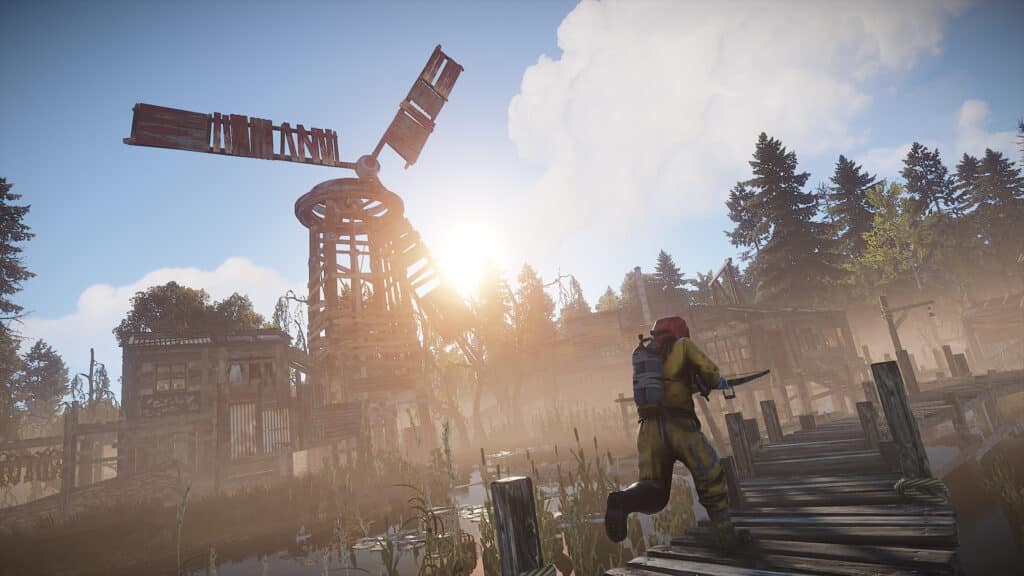 Player running with a crossbow past a windmill in Rust