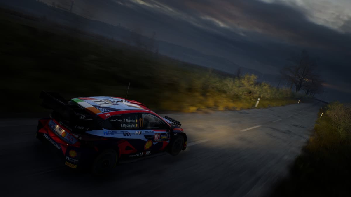 Car racing at night with headlights on in EA Sports WRC